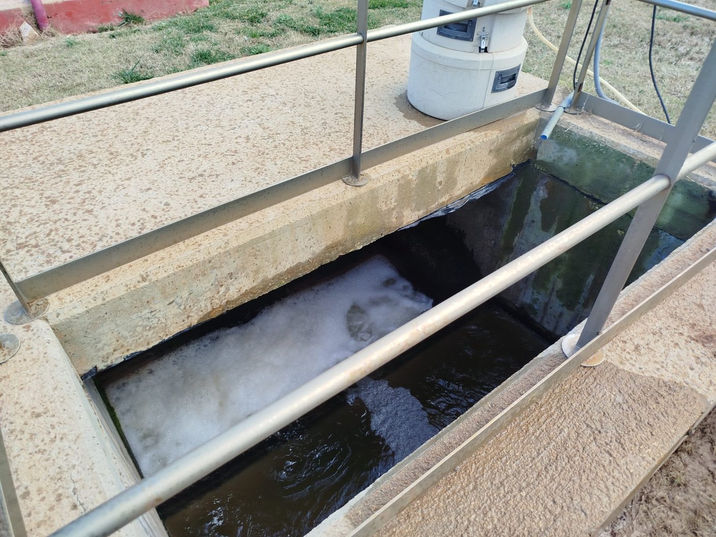 Sampling point in the WWTP outfall channel with the sampling equipment